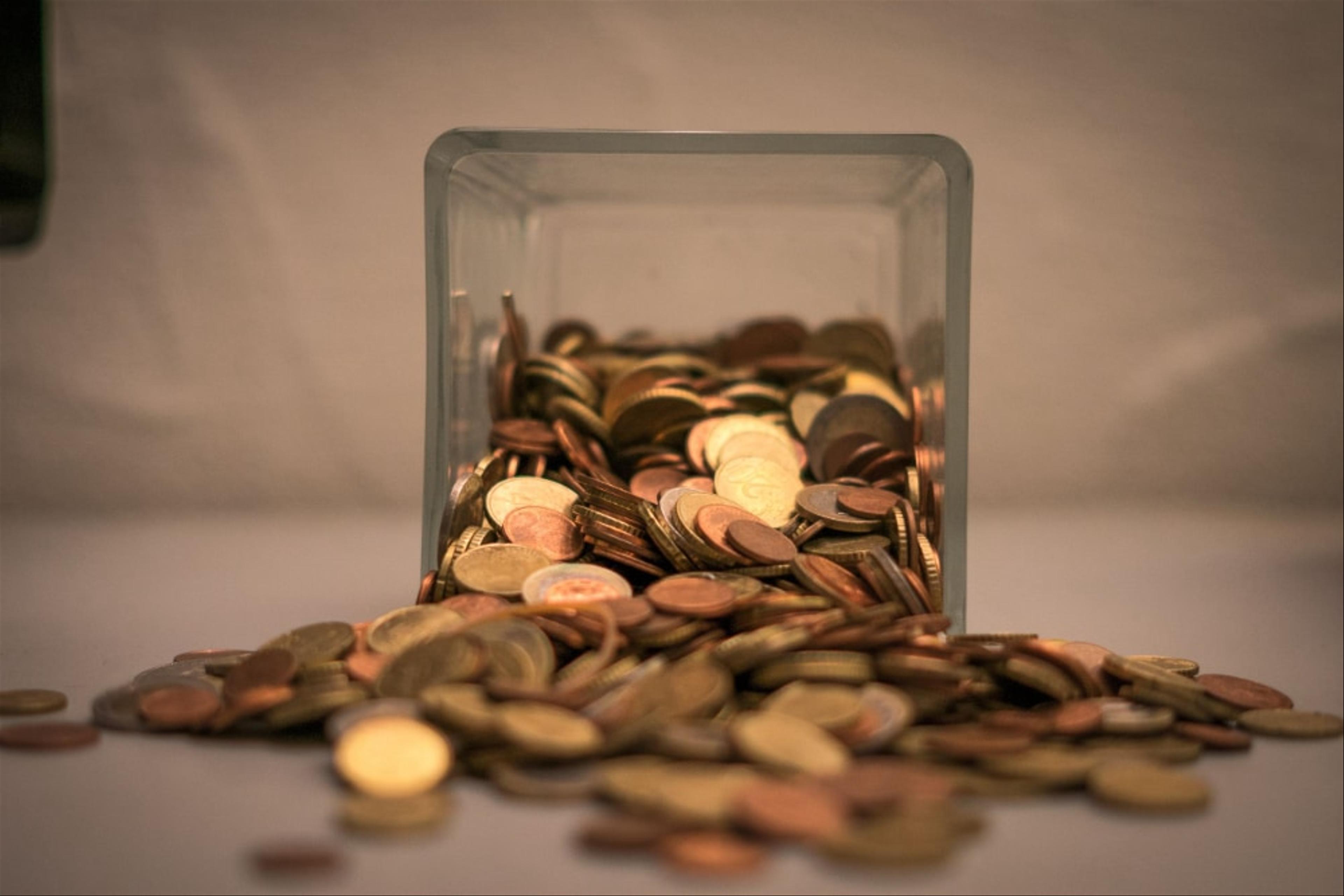 Coins falling out of a jar