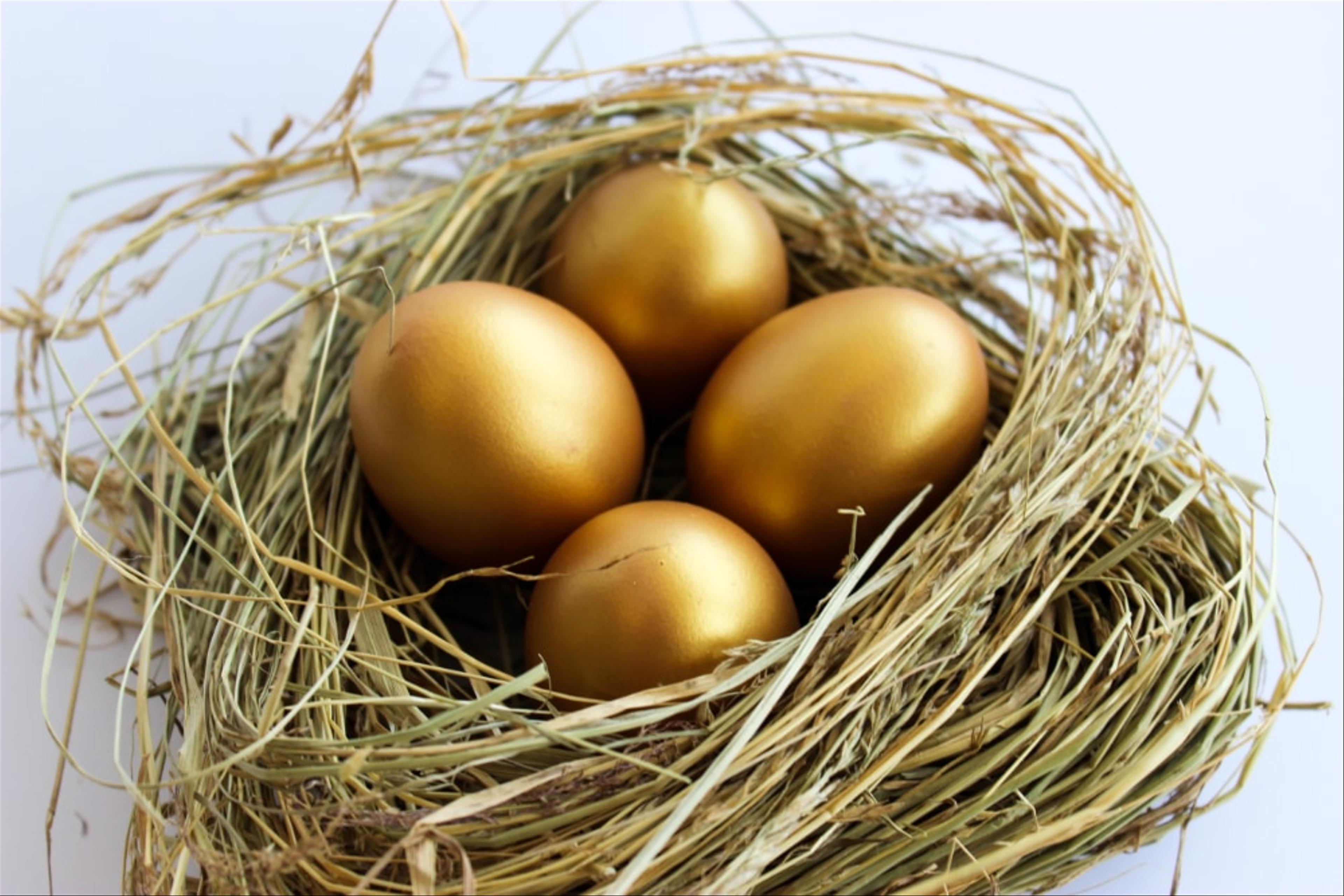 Four golden eggs in a nest